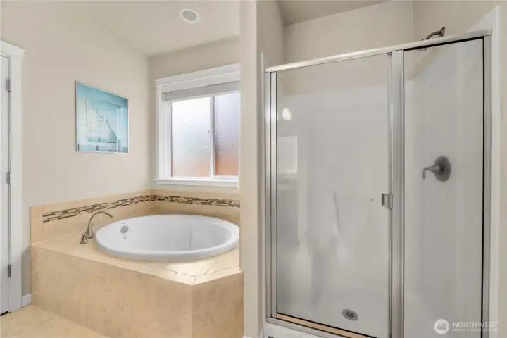 Full tile surround soaking tub and separate shower—designed for both everyday ease and comfort.