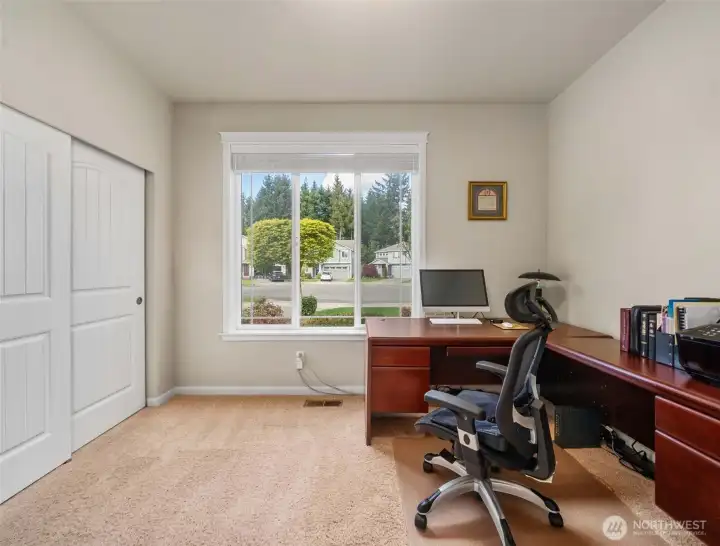 Main-level 2nd bedroom near the front entry with a full bathroom just outside—ideal for guests, a home office, or multi-generational living.