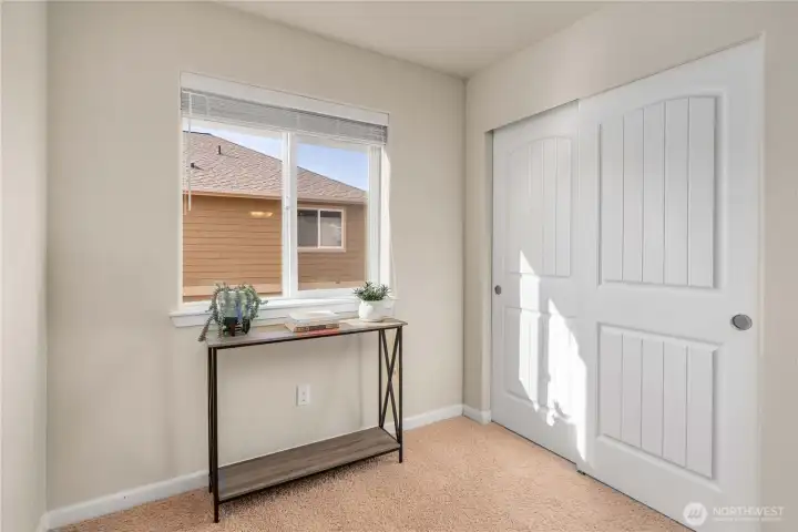 Upstairs landing offers flexible space plus additional closet—perfect for a study nook, reading area, or quiet retreat.