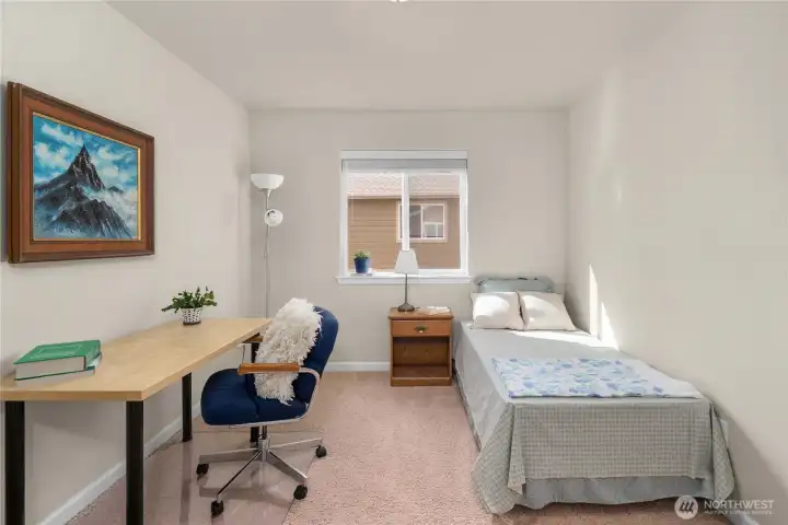 Spacious 3rd bedroom upstairs offers flexibility for guests, workspace, or additional living needs.