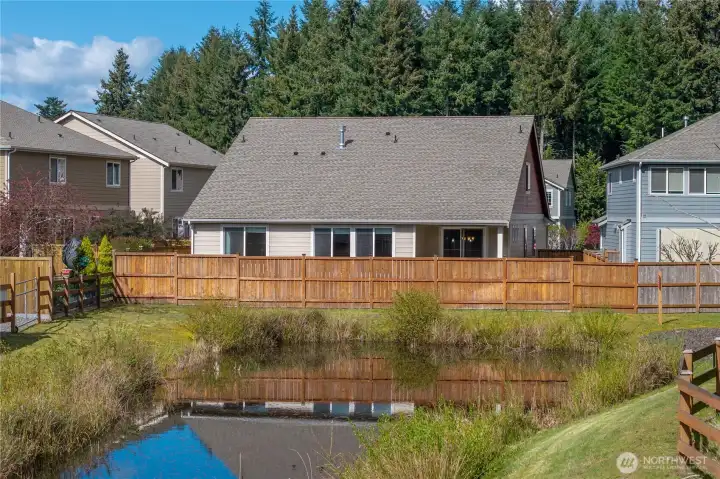 Backyard overlooks a peaceful retention pond with no direct neighbors behind—enhancing privacy and open views.
