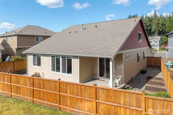 Fully fenced yard and well-maintained exterior offer both privacy and a clean, finished look.