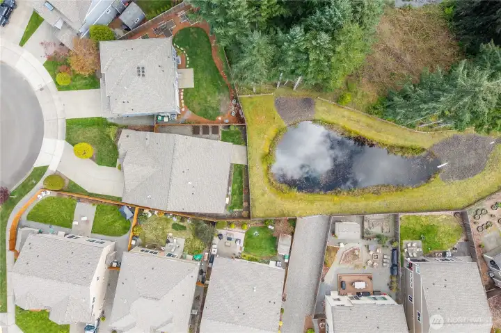 Aerial view highlights the home’s position within the neighborhood and its proximity to open space.