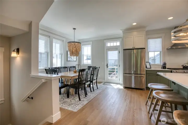 The dining space is elevated with a gorgeous light fixture that can set the mood...