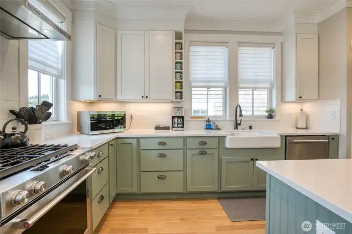 Quartz counters and painted cabinets really feature the farm sink.
