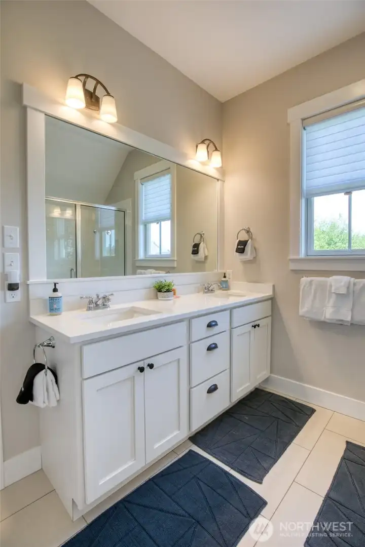 The primary bath offers a double vanity and is spacious.