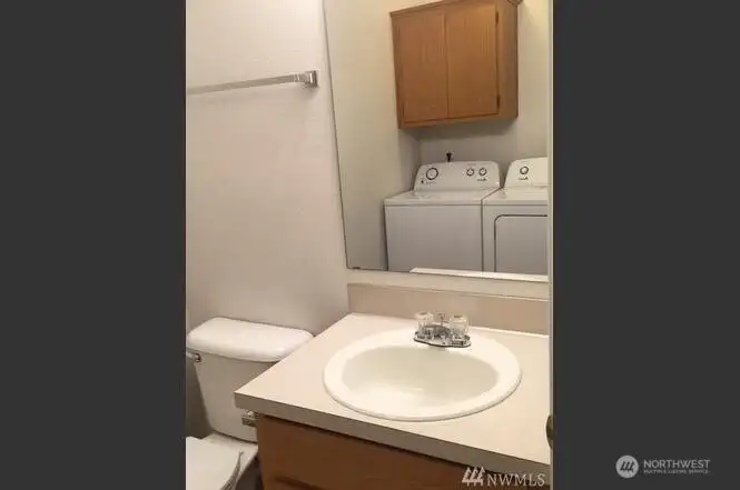 Unit B - Main level half bath & laundry (showing older Washer)