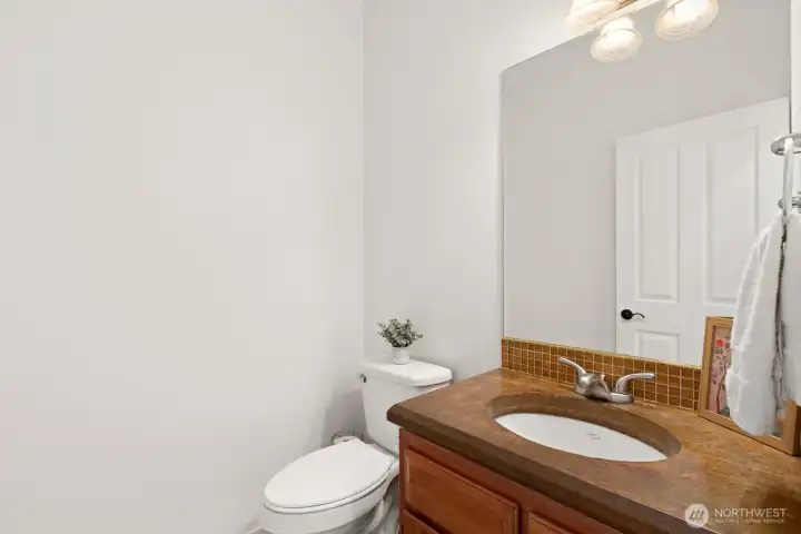 Powder room with custom colored concrete vanity top.