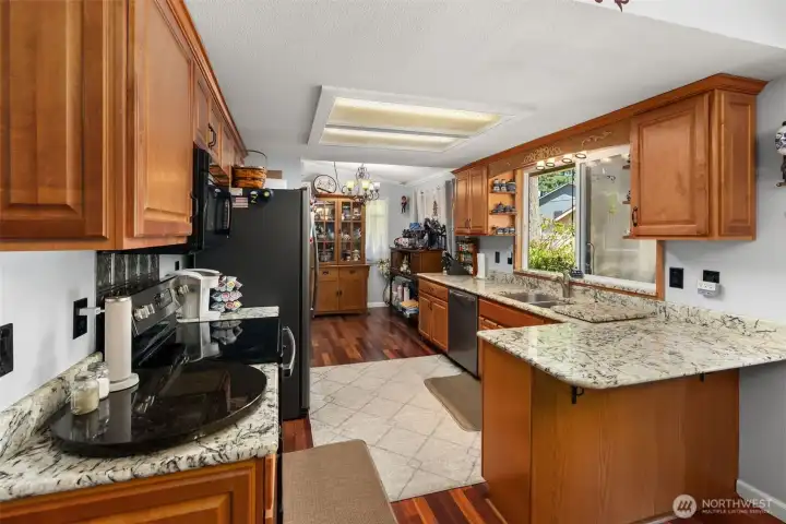 Remodeled kitchen with solid wood cabinetry and granite countertops