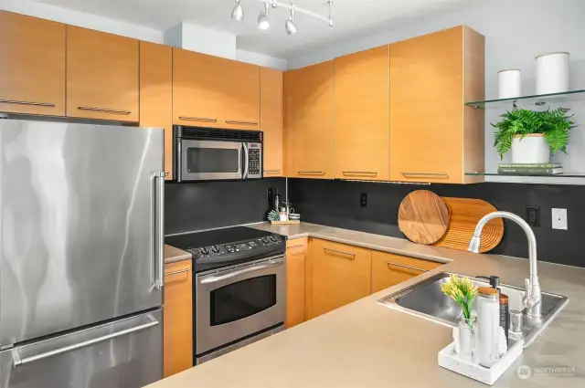 Stainless steel appliances, along with ample counter and storage space, complete the kitchen.
