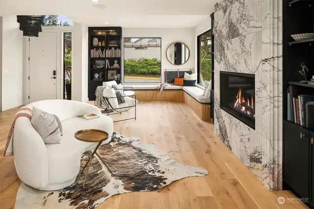 View from dining area into living room, library and home entrance.