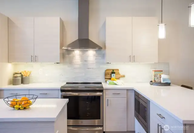 All kitchens have BOTH an island and peninsula and include stainless appliances.  The hood fan is an actual hood fan and not the less functioning micro-hoods.  Under cabinet lighting, soft closing Belmont cabinetry, and an induction range complete these kitchens.