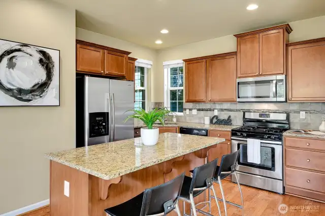 Great kitchen with island and stainless appliances.