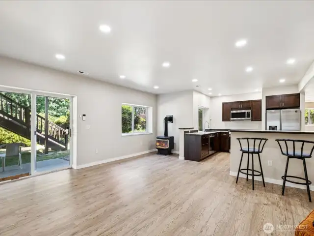 Lower level entry.  New LVP flooring and a fireplace and high ceilings.