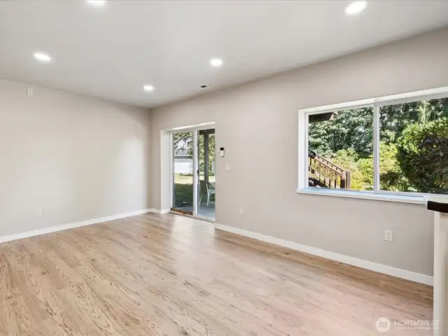 Lower level with private entrance, high ceilings, and new engineered hardwoods (LVP).