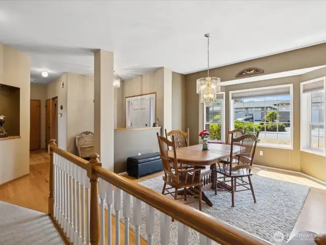 Inviting front entrance.  Hardwood flooring.  Dining room.