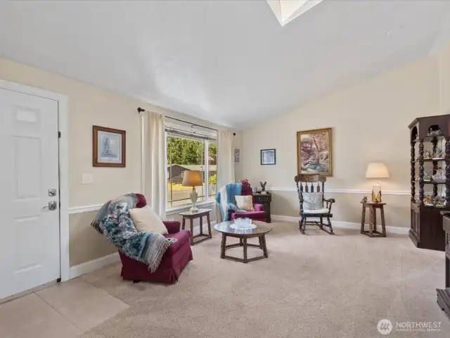 Open floor plan - Living Room has vaulted ceiling & skylight, and opens to Dining Area & Kitchen.