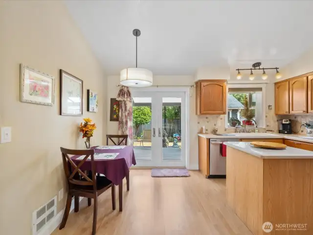 Dining Area opens to the Kitchen with French Doors out to the large covered Trex Deck.