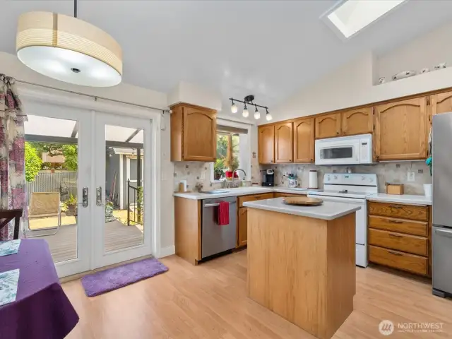 Dining Area opens to the Kitchen with French Doors out to the large covered Trex Deck.