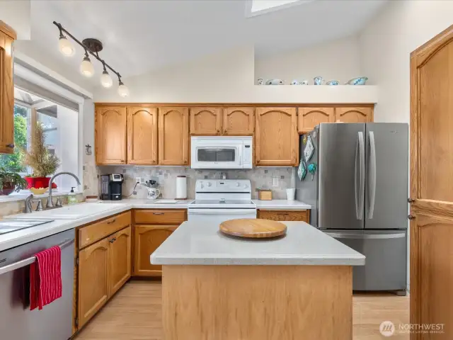 Beautiful Kitchen with vaulted ceiling, skylight,  stainless appliances, garden window & Island.
