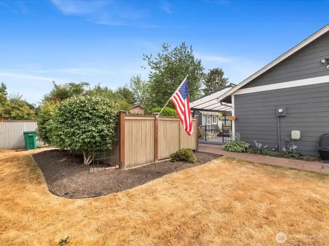 Expansive outdoor spaces with fully fenced Yard, Garden, Raised Beds & Outbuilding/Shed.