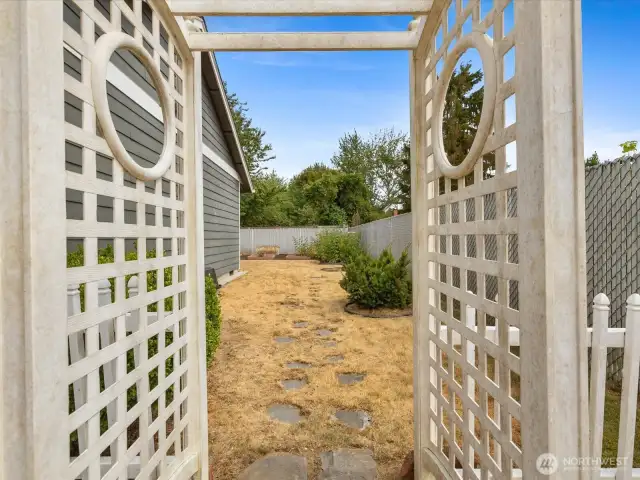 Expansive outdoor spaces with fully fenced Yard, Garden, Raised Beds & Outbuilding/Shed.