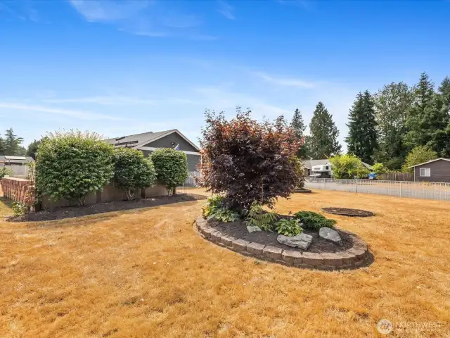 Expansive outdoor spaces with fully fenced Yard, Garden, Raised Beds & Outbuilding/Shed.
