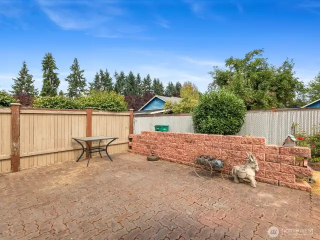 Large Patio with separation fence - leads to covered Deck & front Driveway.