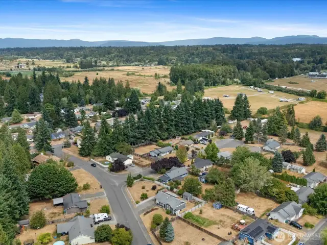 Drone view of the large corner lot and surrounding community.