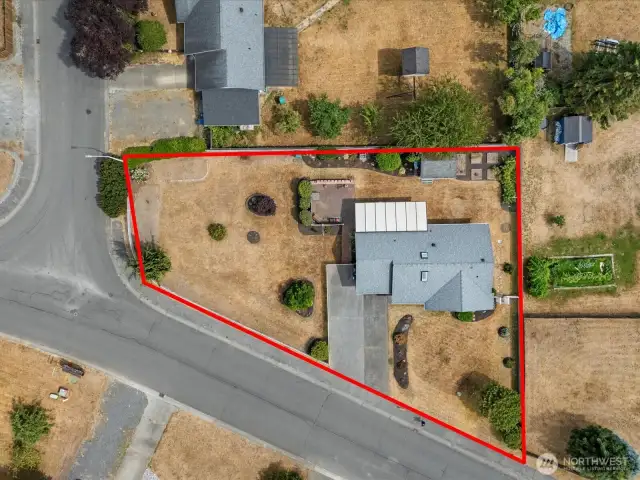 Drone view of the large corner lot and surrounding community.