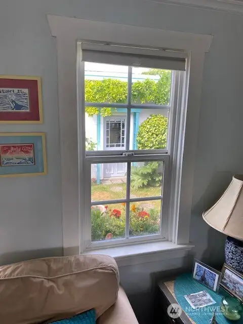Living room with a great view of the gardens and fully fenced yard.