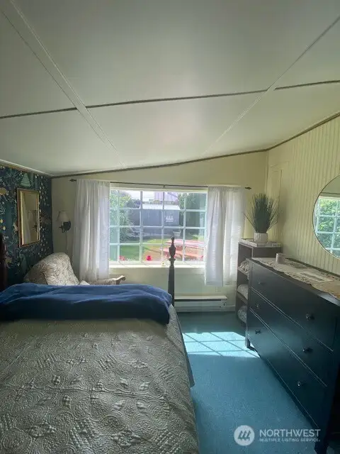 Main bedroom with view of the fully fenced yard and gardens.