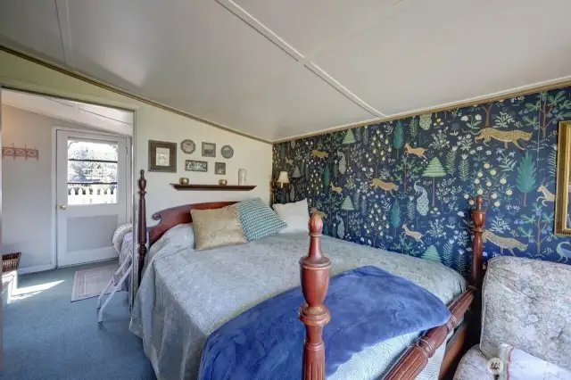 Main bedroom with view of the fully fenced yard and gardens.