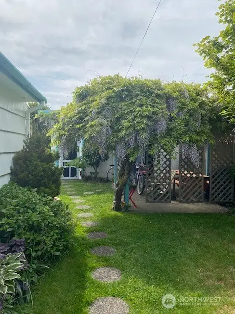 Fully fences yard with mature landscaping