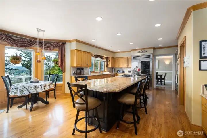 Kitchen has a breakfast nook, marble counter tops, sub zero fridge and Wolf Stove.