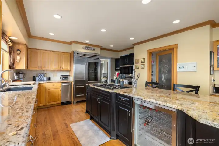 Wine fridge, large kitchen sink, gas cook top, trash compactor, and walk in pantry.