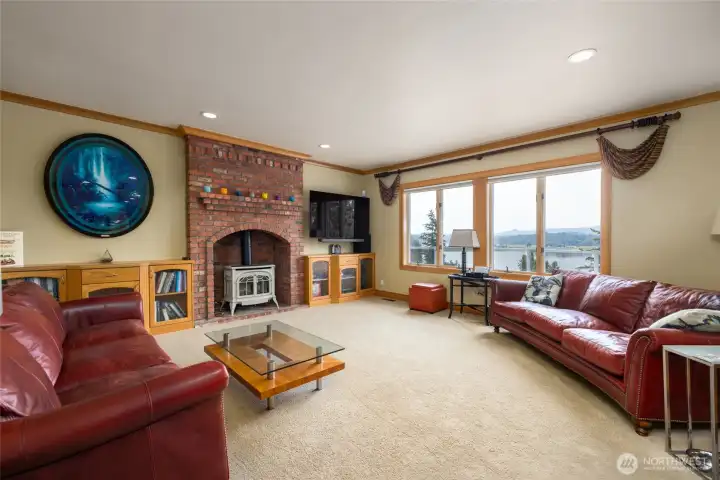 Family room has a cozy gas fireplace and views over the lake.