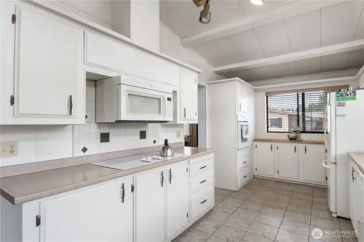 The kitchen features vaulted ceilings