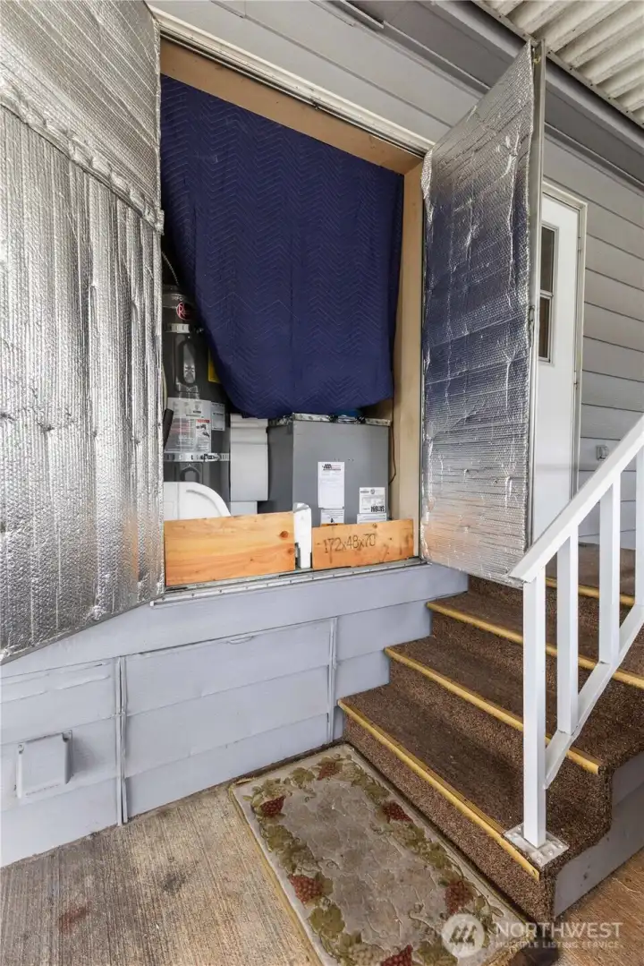 Look at the easy access to the water heater and furnace behind these two large functional doors! This closet situated beside the carport access into the home holds the water heater and furnace