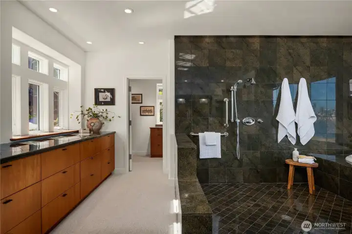 To the left of the enormous tiled shower is the built-in cabinets with a granite top that leads the amazing walk-in closet.