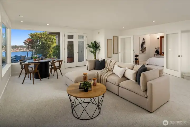 Looking across the rec room towards a bonus room which is set up as a non-conforming bedroom.