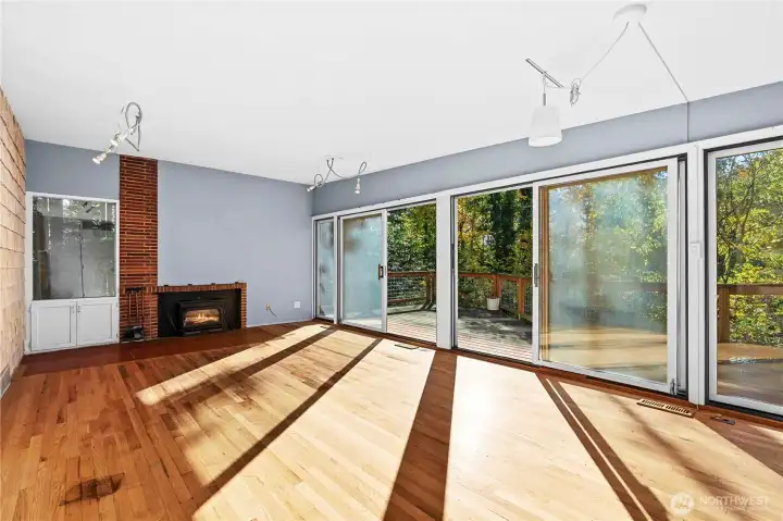 Open floor plan with lots of windows and wood burning insert