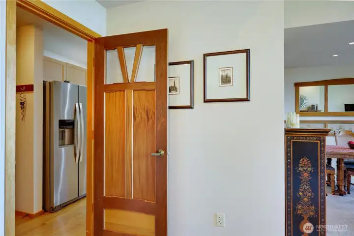 Custom wood door leads from rear hall back into the living room