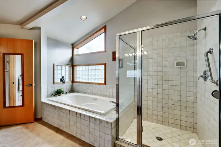 Primary bathroom features large jetted tub and shower.