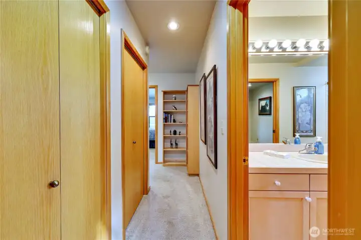 Moving down the hall towards second bedroom and bath.  Doors on left are storage closets.