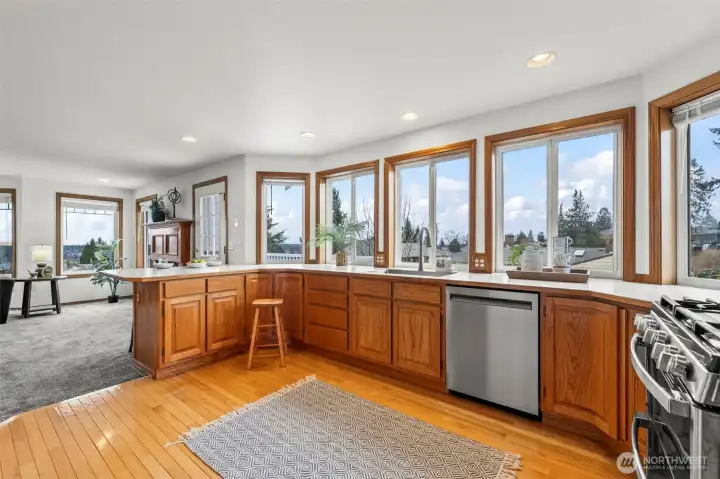 Open airy kitchen with stainless appliances.