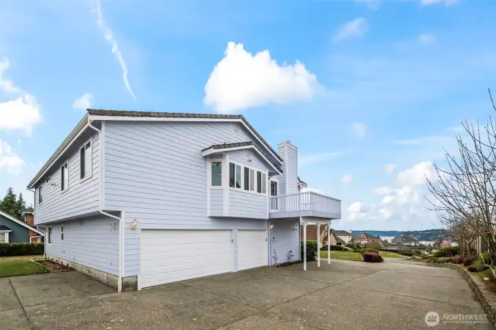 3 car garage tucked away with lots of parking.
