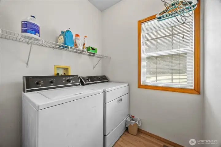 Large laundry room with half bath off attached garage