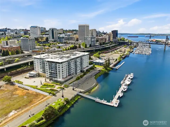 Here is an aerial view of the Esplanade builing, walkway, public dock and Commencement Bay in the distance. The vacant lot shown to the left may eventually be developed as a hotel.