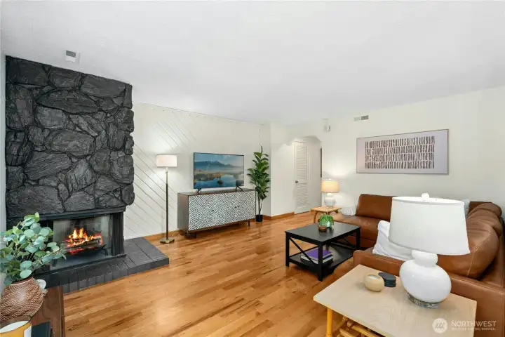 Living Room with woodburning fireplace | Diagonal wood feature wall | Freshly painted alabaster ivory | Facing hallway- front entry